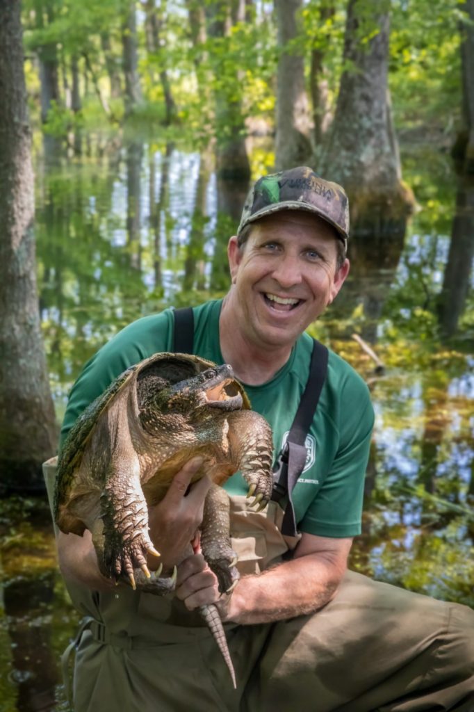 JD Kleopfer holding a snapping turtle